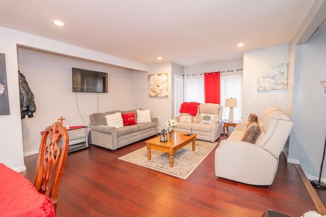 living area with recessed lighting, dark wood-style flooring, and baseboards