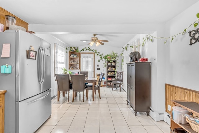 kitchen with stainless steel fridge, ceiling fan, light tile patterned flooring, and vaulted ceiling