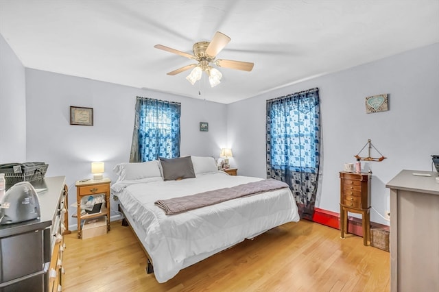 bedroom featuring light hardwood / wood-style floors and ceiling fan