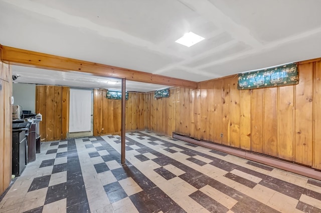 basement featuring wooden walls