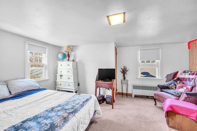 bedroom with light colored carpet and radiator heating unit