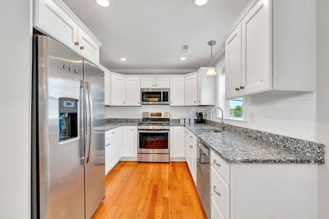 1400 Gorham Unit 3, Lowell, MA 01852 - kitchen with appliances with stainless steel finishes, white cabinets, light wood-style flooring, light stone countertops, and recessed lighting