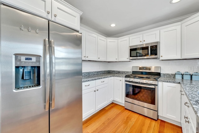 1400 Gorham Unit 3, Lowell, MA 01852 - kitchen with stainless steel appliances, white cabinets, light wood-type flooring, stone counters, and recessed lighting
