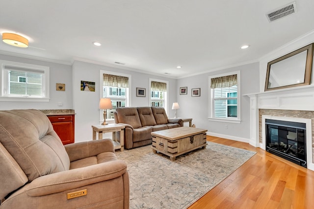 1400 Gorham Unit 3, Lowell, MA 01852 - living room featuring ornamental molding, light wood finished floors, recessed lighting, and a glass covered fireplace