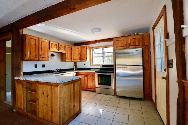 kitchen featuring appliances with stainless steel finishes, kitchen peninsula, sink, and light tile patterned floors