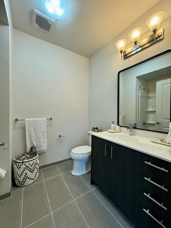 bathroom with tile patterned floors, vanity, and toilet