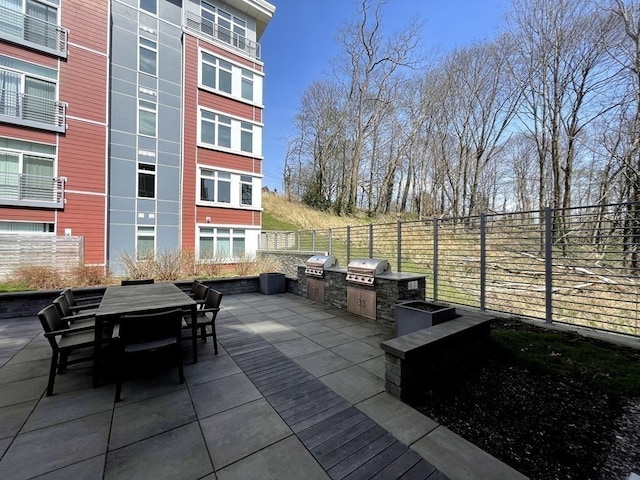 view of patio featuring an outdoor kitchen and a grill