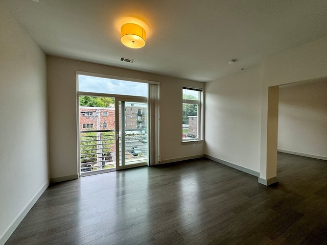 empty room featuring dark hardwood / wood-style flooring