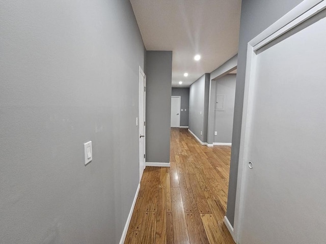 hallway with light hardwood / wood-style floors