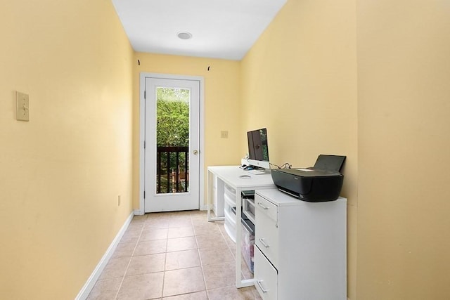 laundry area featuring baseboards and light tile patterned floors