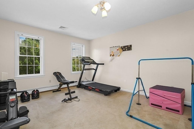 exercise room with carpet floors and baseboards