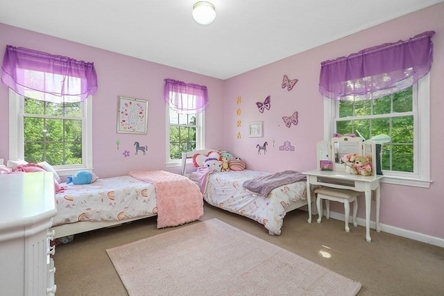 bedroom with carpet flooring and baseboards