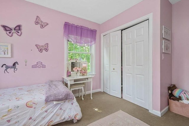 bedroom with carpet flooring, baseboards, and a closet