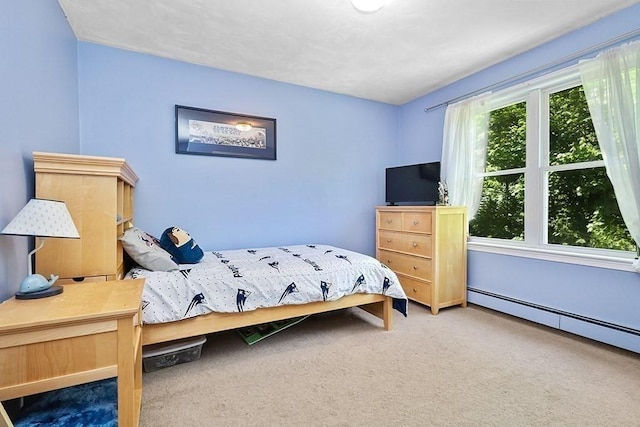 carpeted bedroom with a baseboard heating unit