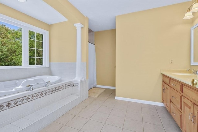 full bath with tile patterned flooring, vanity, ornate columns, a garden tub, and a shower with shower curtain