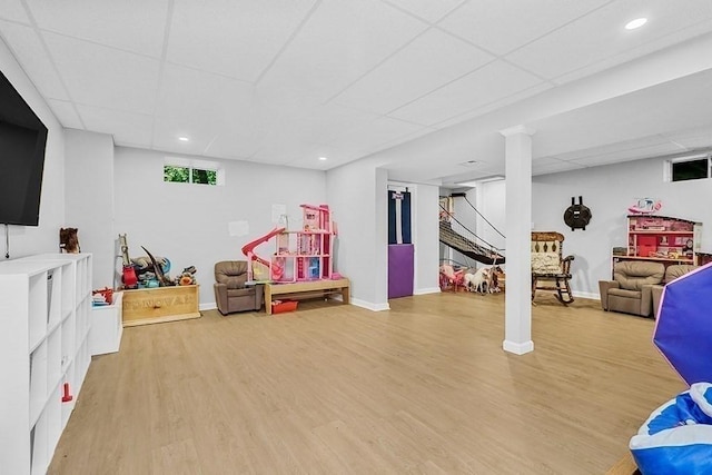 recreation room with a drop ceiling, light wood finished floors, baseboards, and recessed lighting