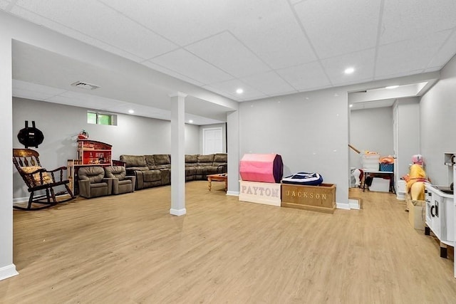 basement with light wood-style flooring, a drop ceiling, baseboards, and recessed lighting