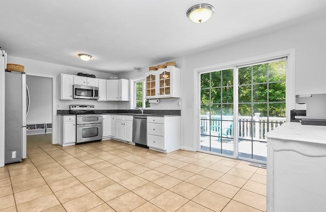kitchen featuring appliances with stainless steel finishes, plenty of natural light, and white cabinetry