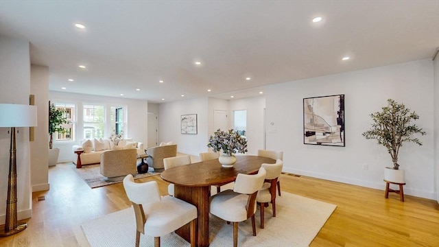 dining area with light wood finished floors, recessed lighting, and baseboards
