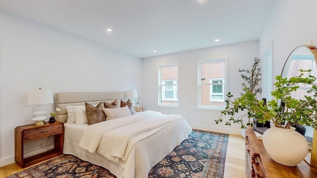 bedroom with multiple windows, baseboards, recessed lighting, and wood finished floors