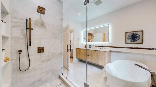 full bathroom with a shower stall, a freestanding tub, vanity, and tile patterned floors