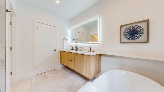 full bathroom with a freestanding tub and double vanity
