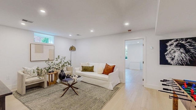 living room featuring light wood-style floors, recessed lighting, and baseboards