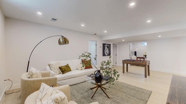 living room with recessed lighting, baseboards, and light wood-style floors