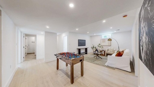 game room featuring light wood-style floors, recessed lighting, and baseboards