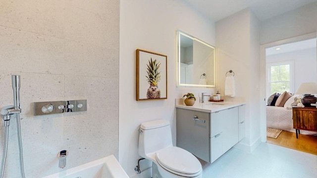 full bathroom featuring toilet, connected bathroom, a bath, and vanity
