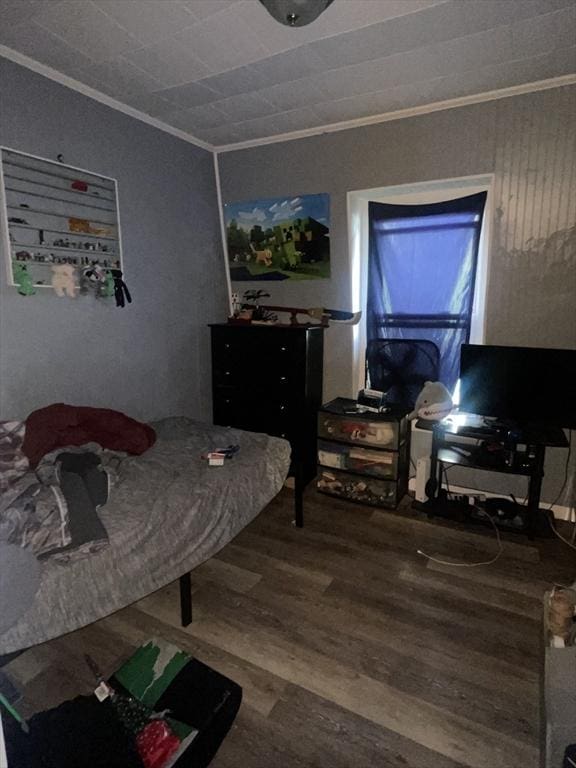 bedroom with hardwood / wood-style flooring and crown molding