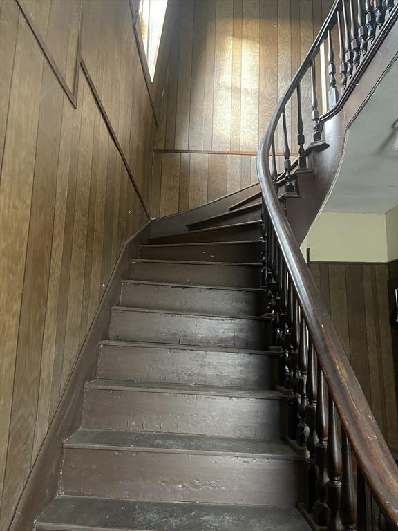 stairway with wood walls