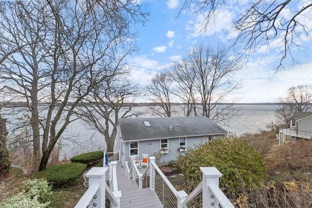 69 Naugus Ave, Marblehead, MA 01945 - back of house with a water view and roof with shingles
