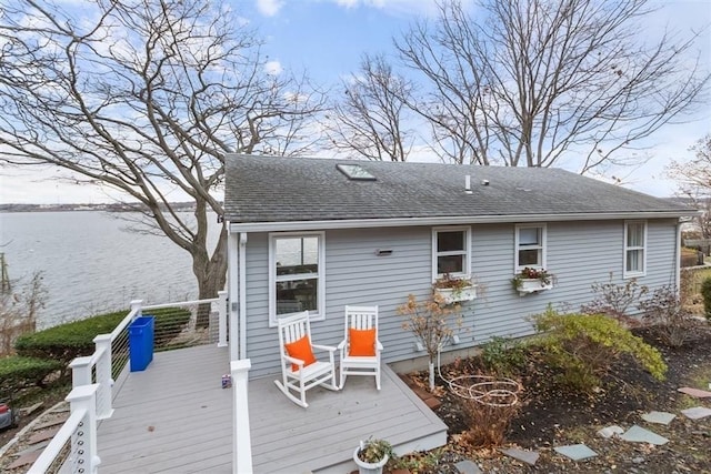 69 Naugus Ave, Marblehead, MA 01945 - back of property featuring a deck with water view and a shingled roof