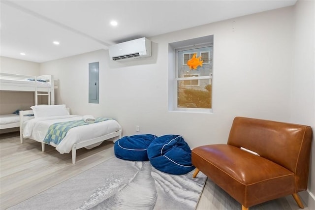 69 Naugus Ave, Marblehead, MA 01945 - bedroom featuring an AC wall unit, recessed lighting, electric panel, and wood finished floors