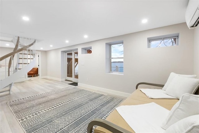 69 Naugus Ave, Marblehead, MA 01945 - living area featuring a wall mounted air conditioner, stairs, recessed lighting, wood finished floors, and baseboards