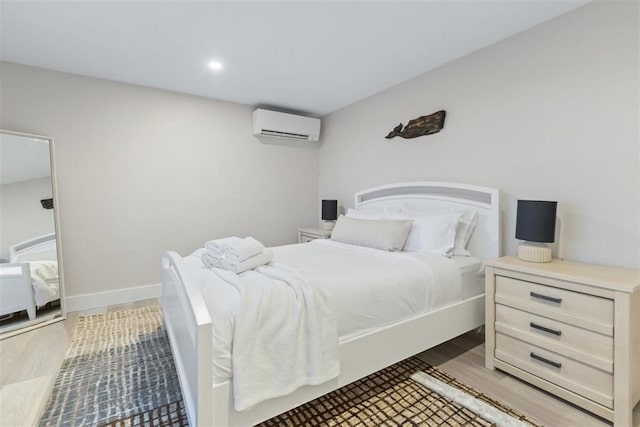 69 Naugus Ave, Marblehead, MA 01945 - bedroom with an AC wall unit, wood finished floors, and recessed lighting