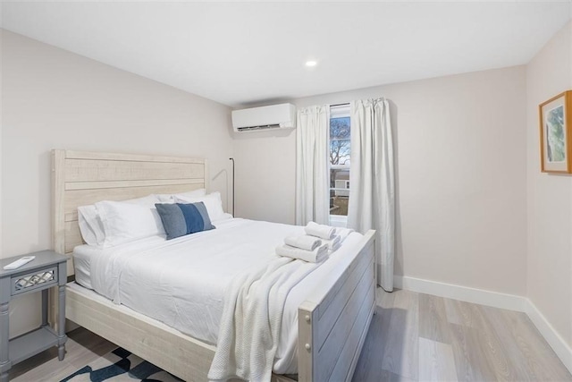 69 Naugus Ave, Marblehead, MA 01945 - bedroom featuring a wall mounted AC, light wood-type flooring, baseboards, and recessed lighting