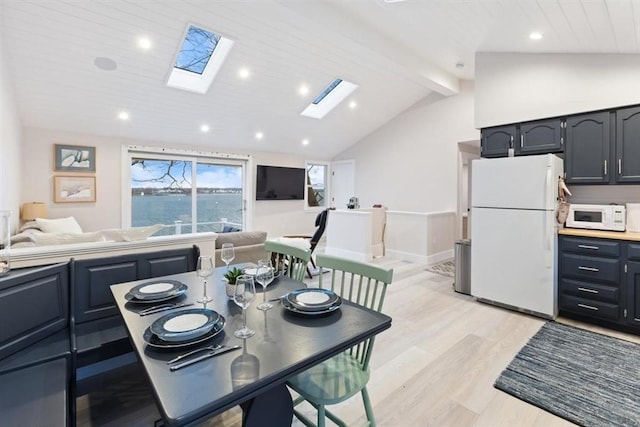 69 Naugus Ave, Marblehead, MA 01945 - dining room featuring a skylight, recessed lighting, light wood-style floors, and baseboards