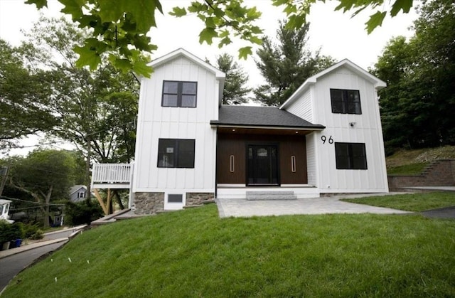 96 Dutton St, Malden, MA 02148 - modern farmhouse with board and batten siding, a front yard, and roof with shingles