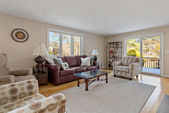 living room featuring plenty of natural light and light hardwood / wood-style floors