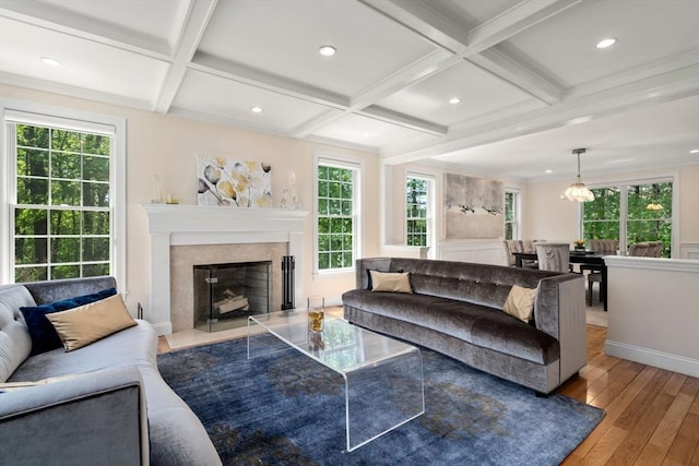 living room with hardwood / wood-style flooring, coffered ceiling, a fireplace with flush hearth, beamed ceiling, and recessed lighting