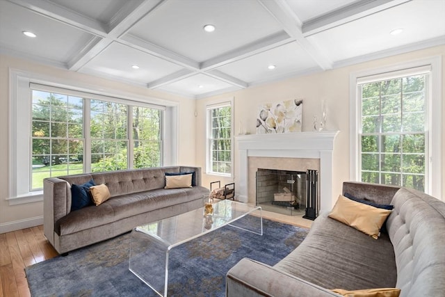 living room with coffered ceiling, hardwood / wood-style floors, plenty of natural light, beam ceiling, and a fireplace