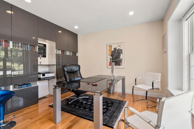 home office with light wood-style floors, baseboards, and recessed lighting