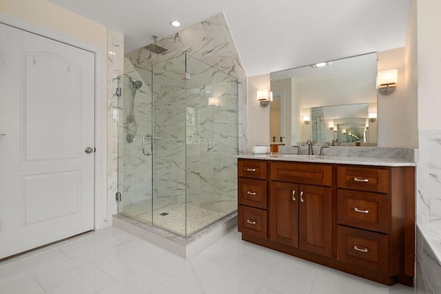 full bathroom with a marble finish shower, vanity, and tile patterned flooring