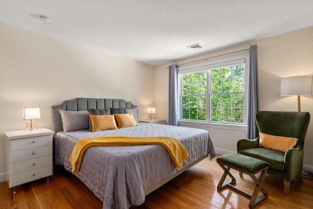 bedroom featuring hardwood / wood-style flooring and baseboards