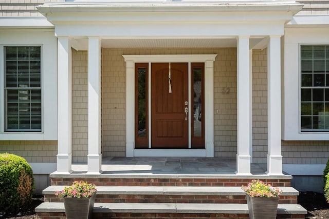 entrance to property featuring covered porch
