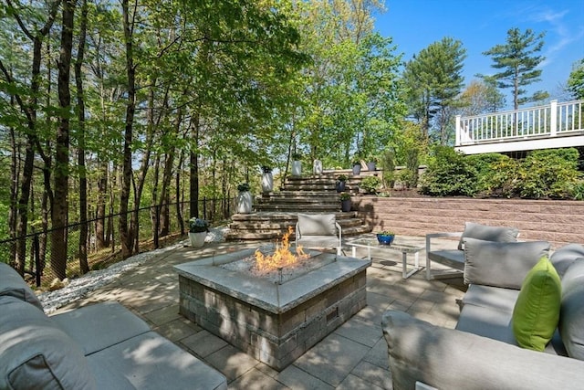 view of patio / terrace with an outdoor living space with a fire pit