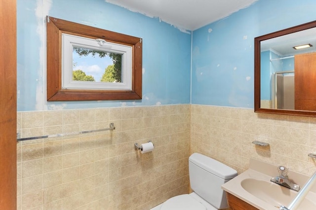 209 S St, Wrentham, MA 02093 - bathroom featuring toilet, vanity, tile walls, a shower with shower door, and a wainscoted wall