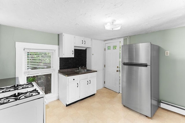 209 S St, Wrentham, MA 02093 - kitchen featuring freestanding refrigerator, a baseboard radiator, white range with gas cooktop, a sink, and plenty of natural light